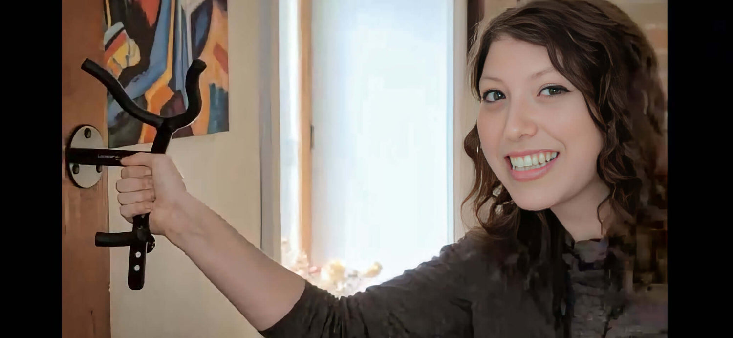 female music teacher demonstrating sturdy wall-mounted saxophone stand by Locoparasaxo