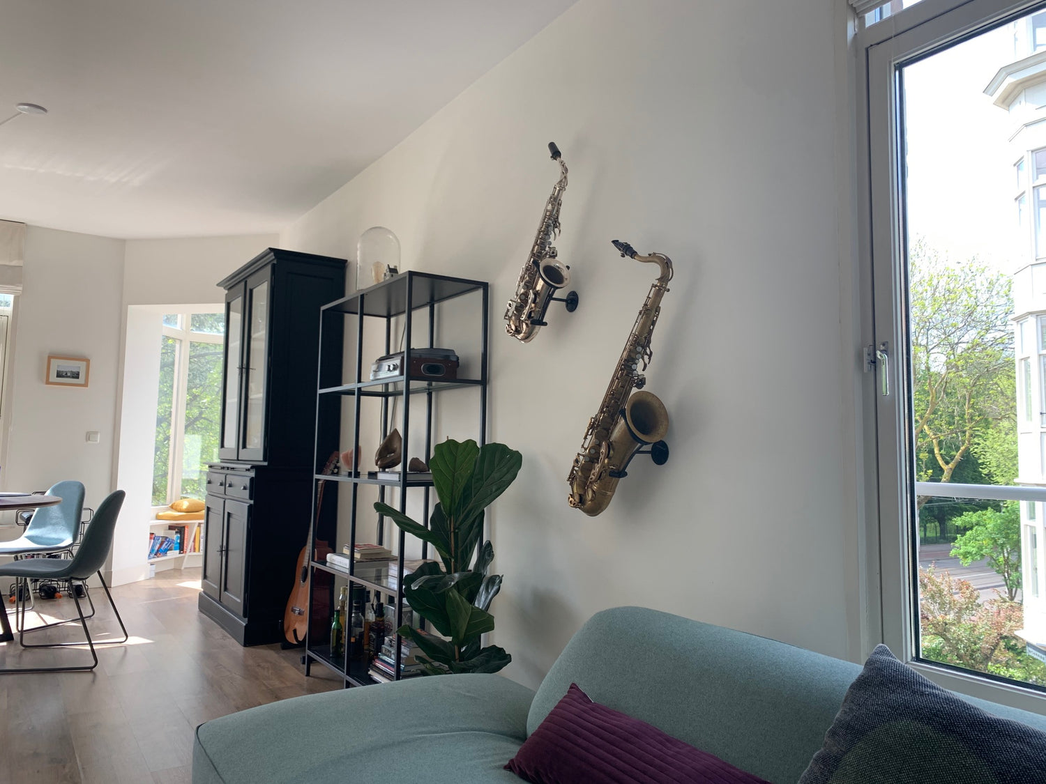 bright familyroom with sofa and two saxophones mounted on the wall
