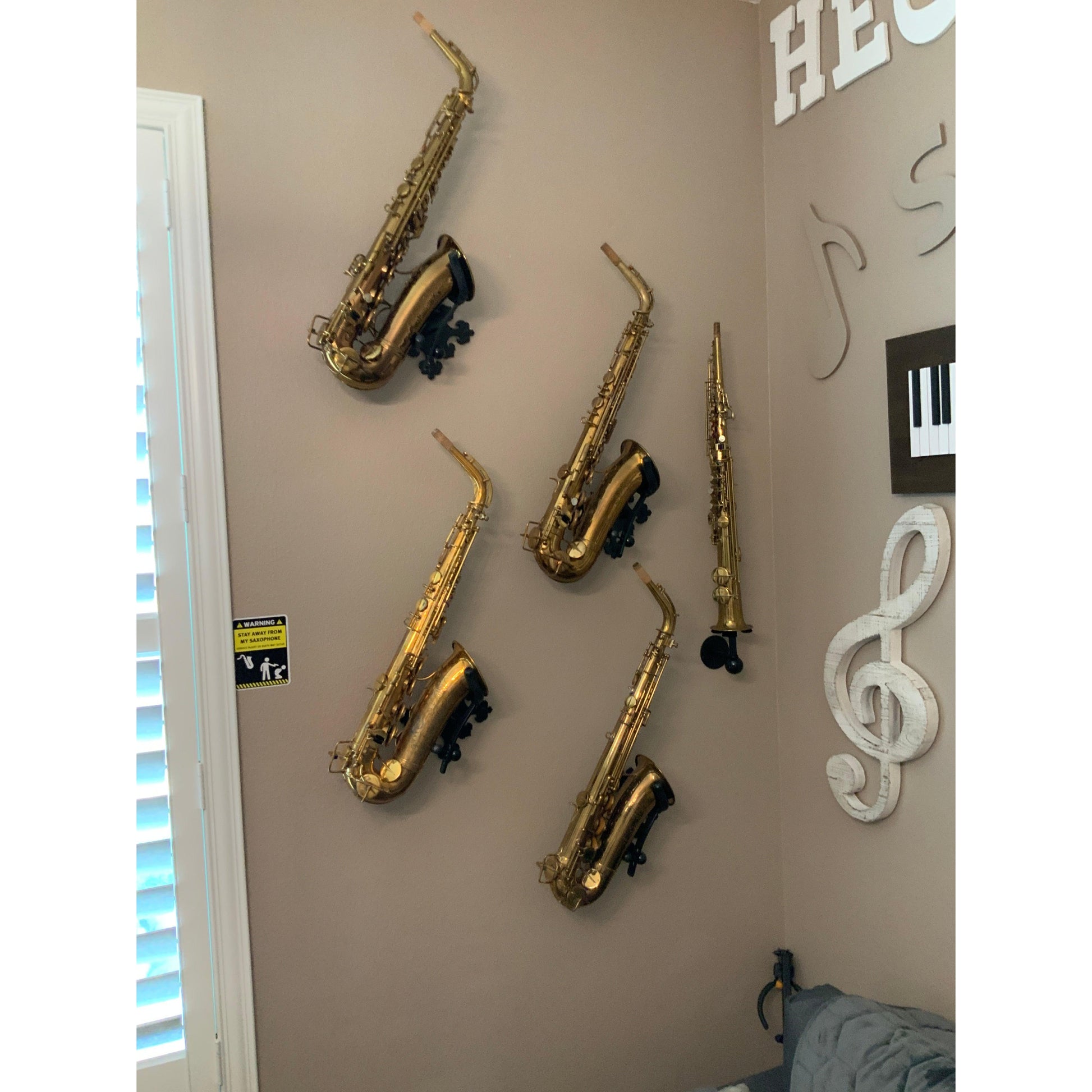 customer wall dedicated to music with five saxophones alto soprano in Locoparasaxo wallmounted stand