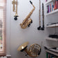 collection of musical instruments saxophone in wallmounts at a customers study